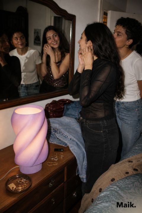 Sculptural lamp on a dresser at night