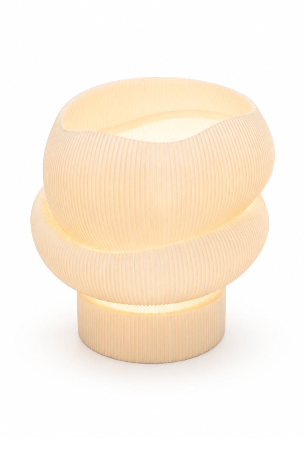 A cream coiled printed lamp glowing at the seams