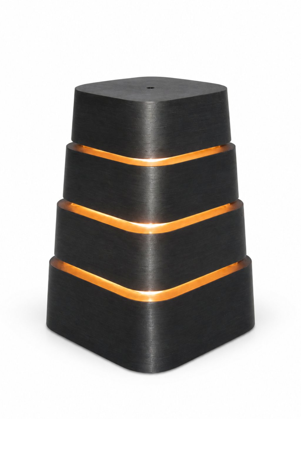 Four stacked black printed modules with light escaping the joins