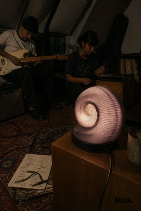 Arch lamp lit on a coffee table during a card game